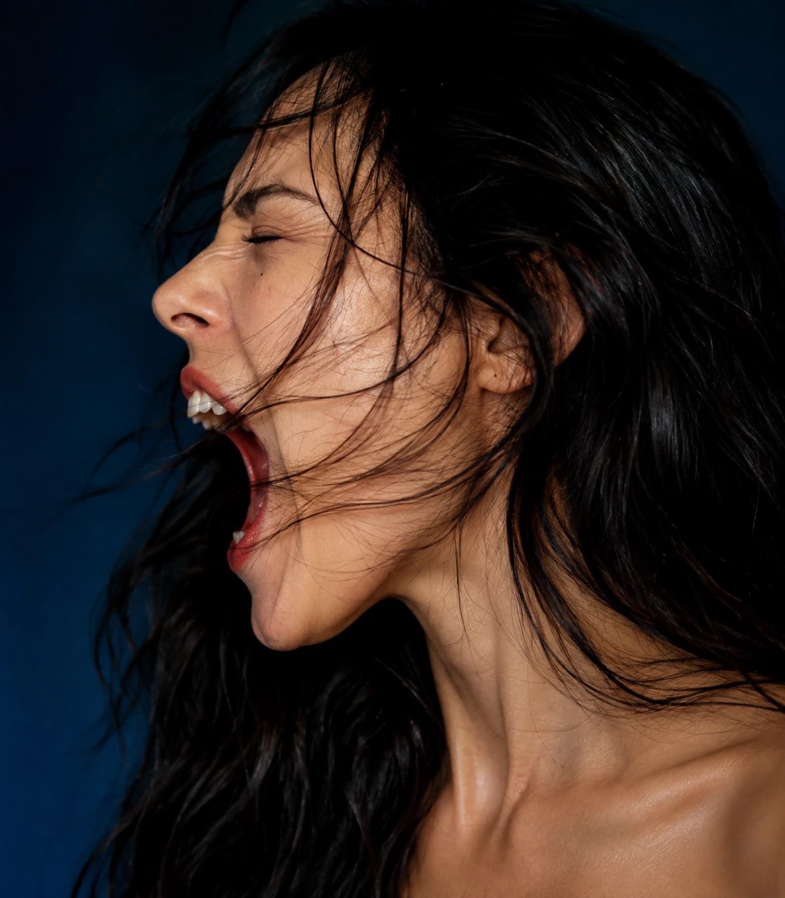 A woman captured mid-shout, raw and unfiltered